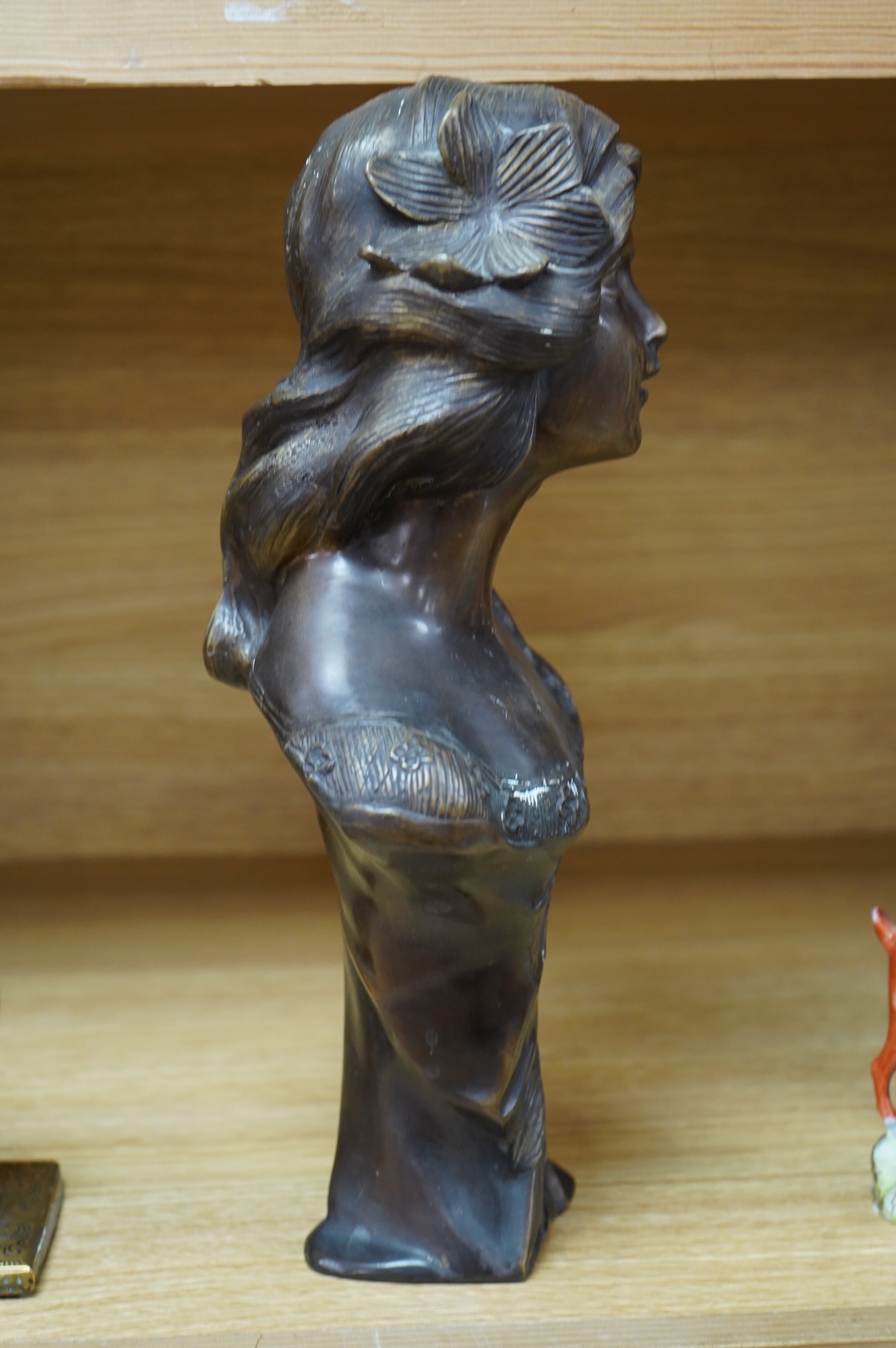 A French Art Nouveau bronze bust of a maiden, unsigned, 32cm high